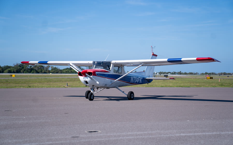 The Alpha Company Aviation Cessna 150, a red white and blue trainer, on the ramp at Venice Municipal Airport